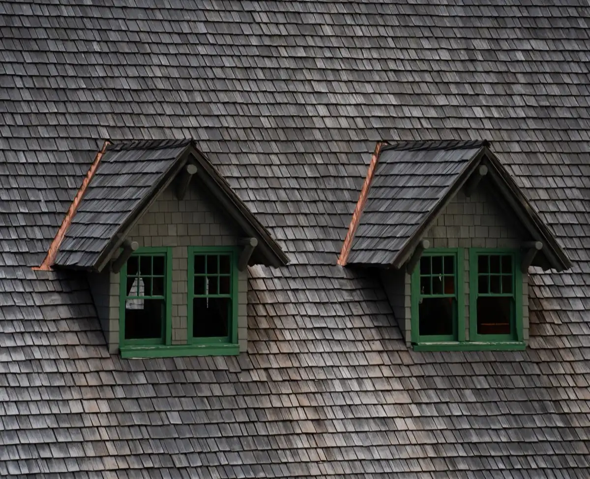 Dormers on a shingle roof in Fort Smith, AR, where step flashing and kickout flashing carry water past the walls